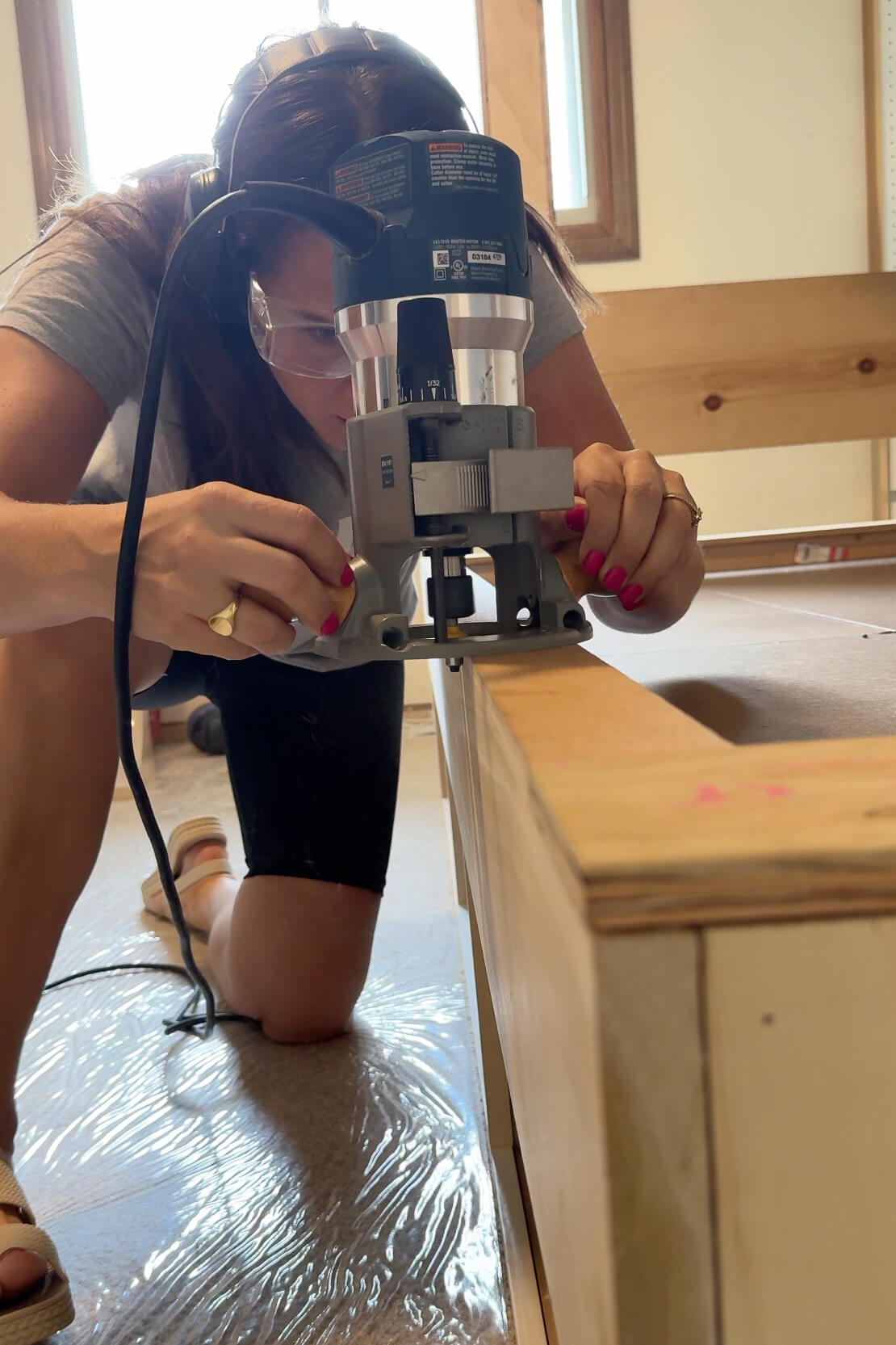 Using a router to round off the corners on a DIY bunk bed.